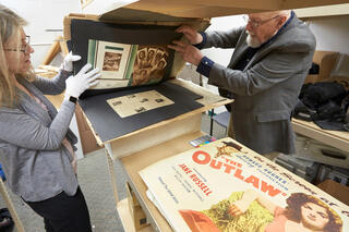 A librarian and professor look through ephemera from the 1946 movie &quot;The Outlaw&quot; in the Howard Hughes Collection at UNLV.